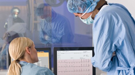 profissionais clínicos a monitorizarem eletrocardiógrafos de pacientes